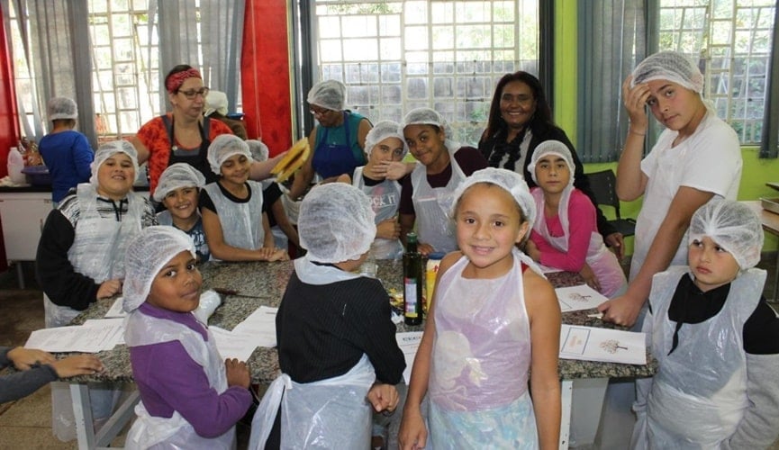 Foto de crianças cozinhando durante oficina em Campo Limpo Paulista