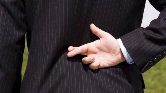 Homem com dedos cruzados