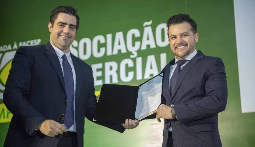 Presidente da Associação Comercial Emrpesarial de Jundiaí Elton Monteiro e o presidente eleito, Mark William Ormenese Monteiro,seguram o termo de posse para a gestão 2020/2021 e d