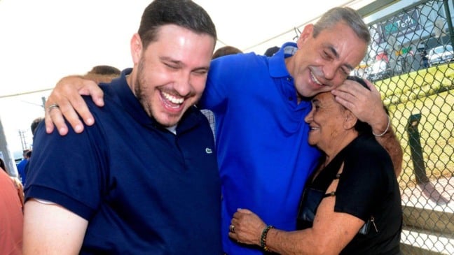 Professor Rodolfo e João Paulo abraçando moradora de Várzea Paulista