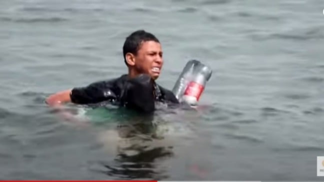 Jovem migrante chega à praia flutuando em garrafas plásticas