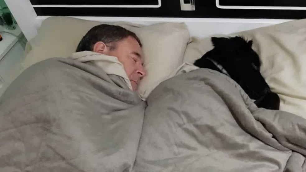 Homem dormindo com cachorro