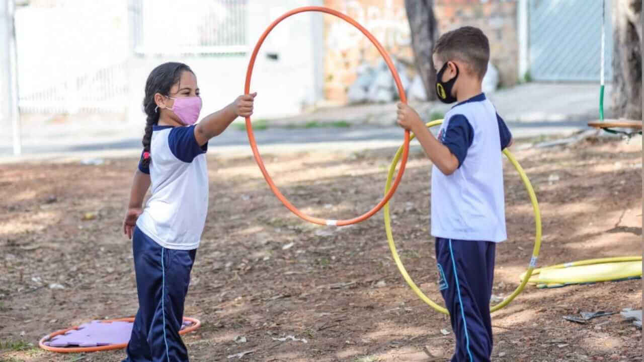 Crianças brincando com bambolê