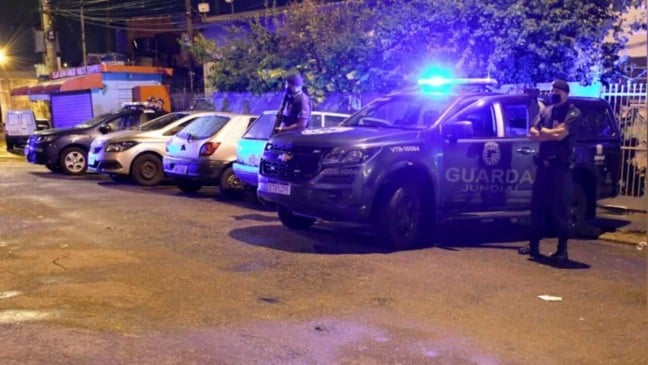 Viaturas da Guarda Municipal de Jundiaí estacionadas à noite, com luzes das sirenes ligadas