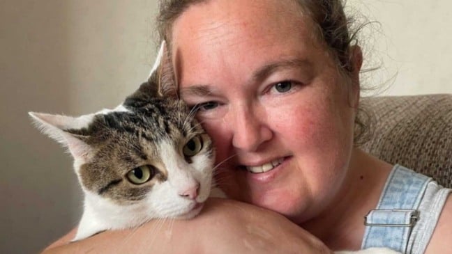 Mulher abraçando gato