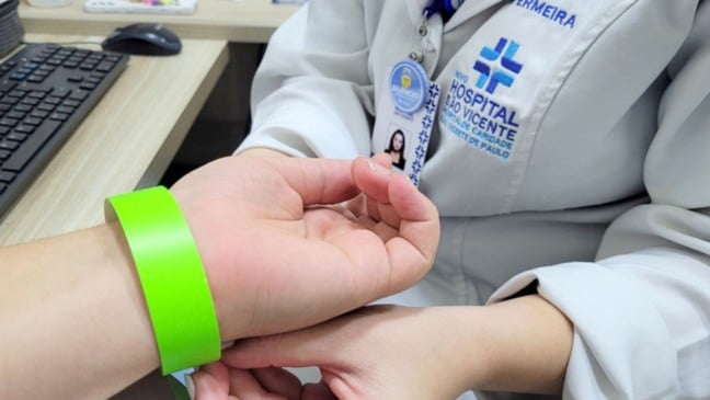 Mulher colocando pulseirinha