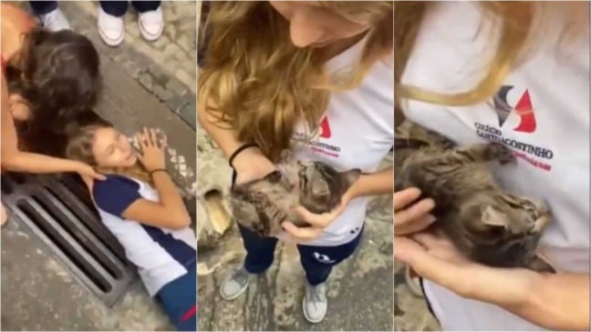 Menina resgatando gato de bueiro