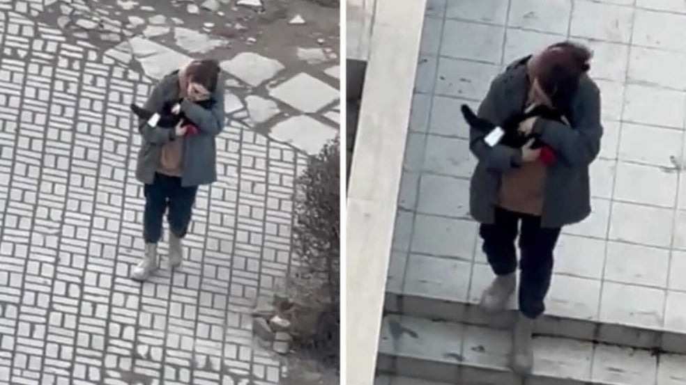 Mulher carregando gato no colo