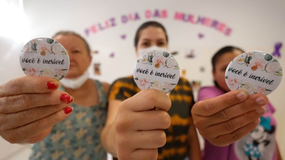 Mulheres segurando bottons