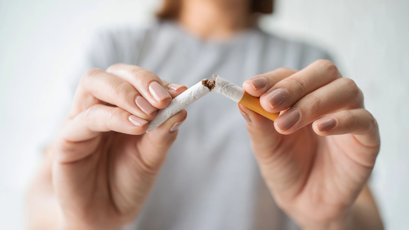 Mulher quebrando um cigarro