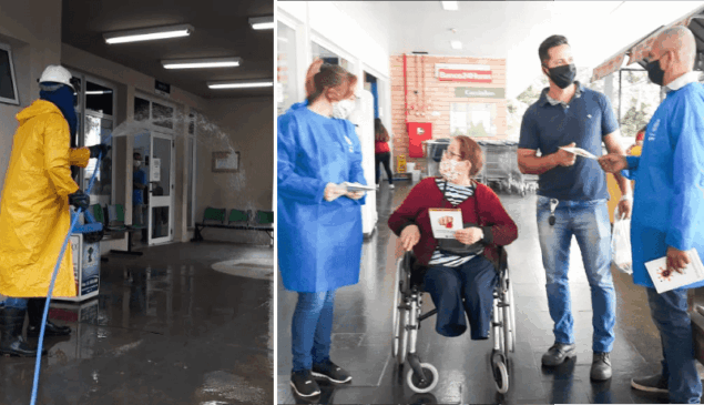 Funcionário faz desinfecção de rua, enquanto equipes entregam folhetos e máscaras