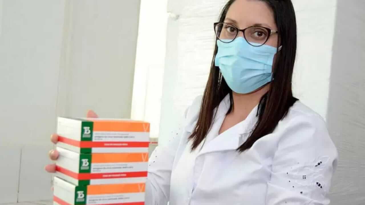 Mulher com caixas de doses da vacina contra Covid19