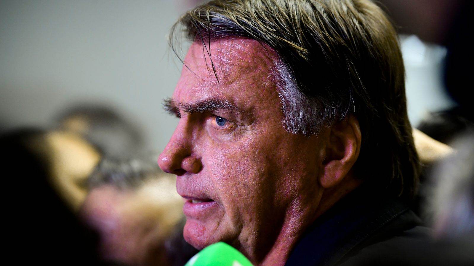 Jair Bolsonaro em close, olhando para o lado, durante declaração à imprensa.