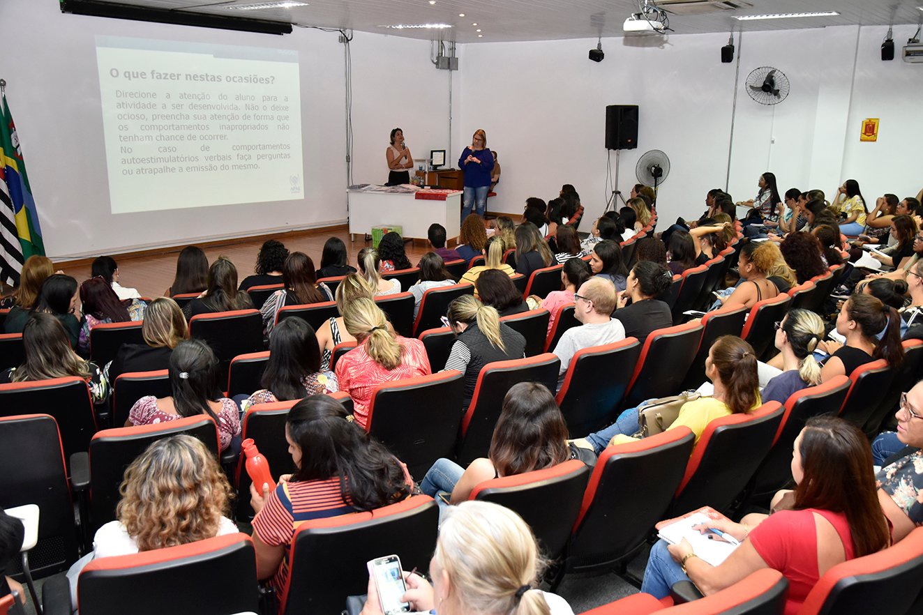 Professores acompanham palestra em auditório