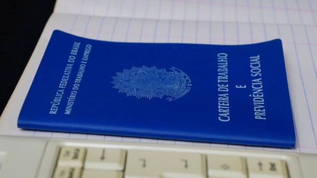 Carteira de trabalho sobre caderno.