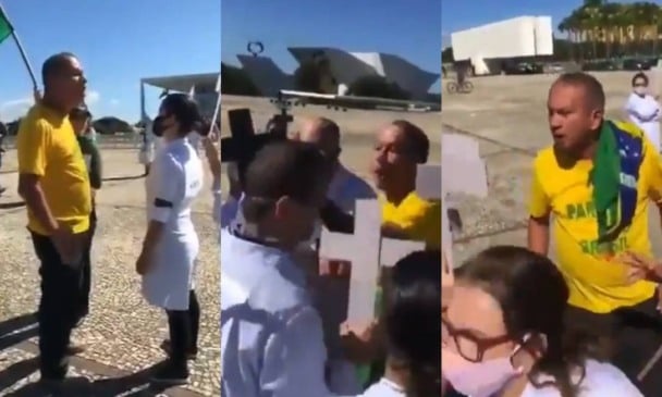 Cada enfermeiro segurava uma cruz em homenagem aos colegas mortos. Eles foram abordados por um grupo com as cores do Brasil (Foto: Reprodução redes sociais)