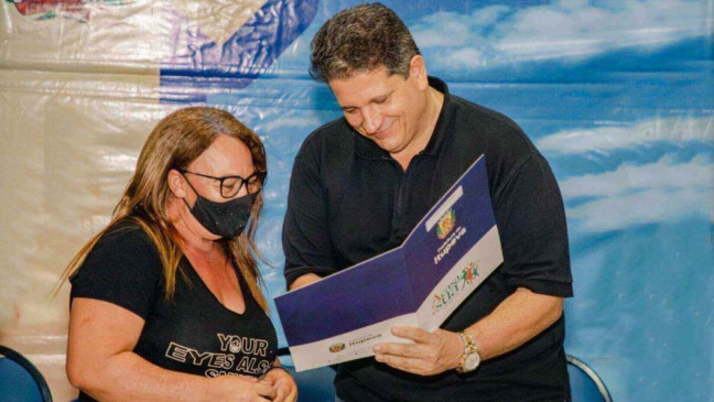 Prefeito de Itupeva entregando a escritura de casa para moradora, no programa "A casa é sua"