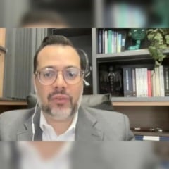 Carlos Silva Filho fala durante videoconferência do CIESP Jundiaí sobre resíduos plásticos, com prateleiras de livros ao fundo e interface online mostrando os demais participantes.