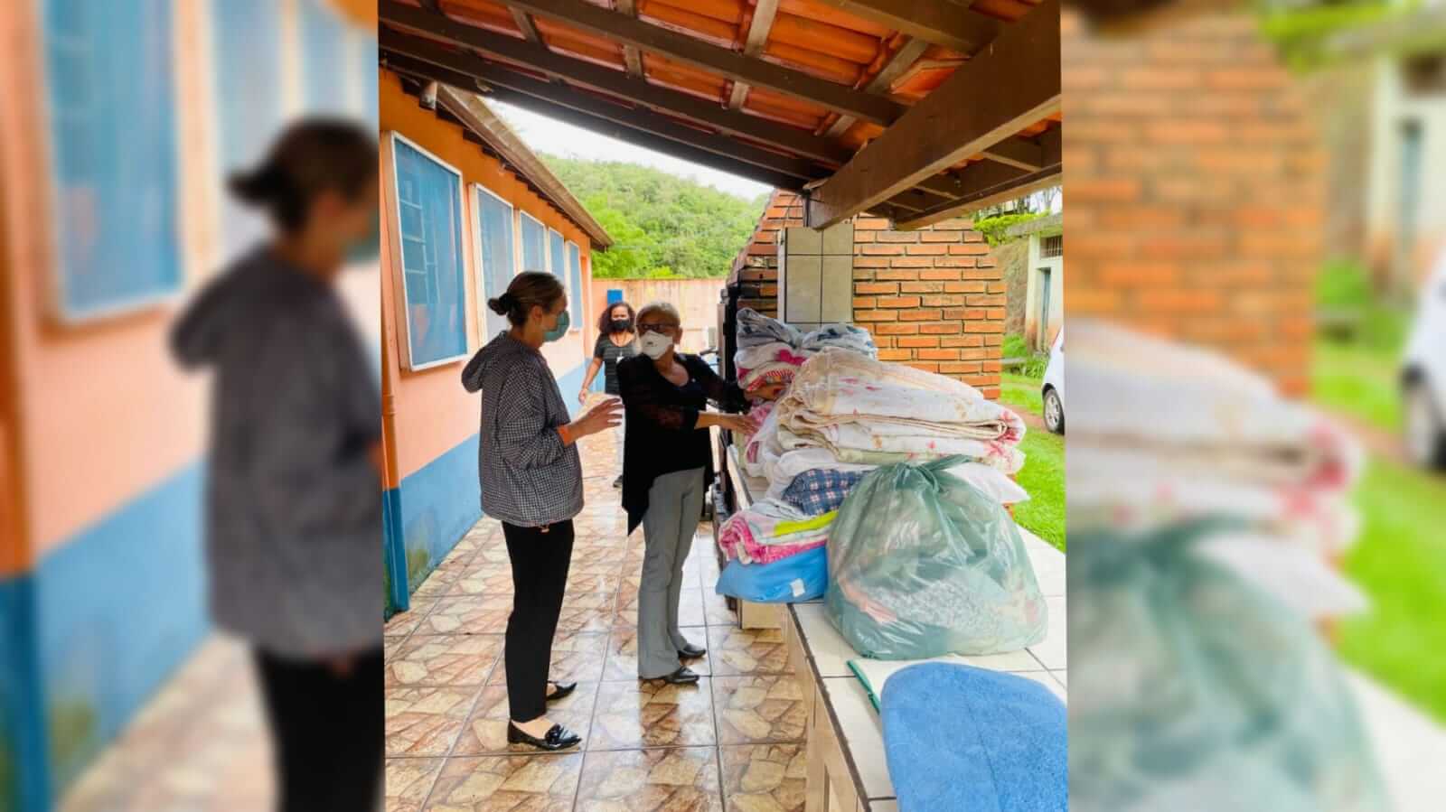 Duas mulheres em uma casa vendo as doações que receberam, após perderem suas casa com as fortes chuvas