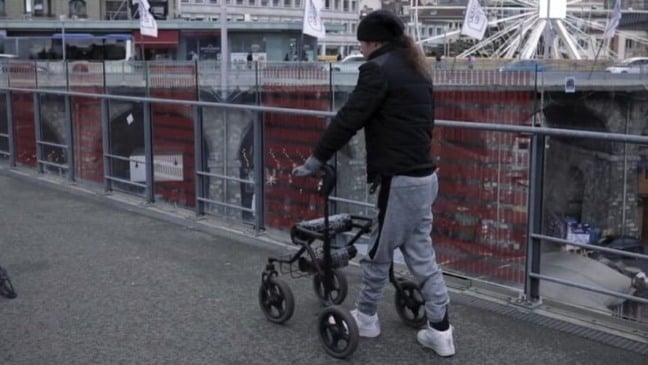 Um sistema conectado ao andador e controlado com botões estimula o movimento das pernas (foto: Reprodução/YouTube)