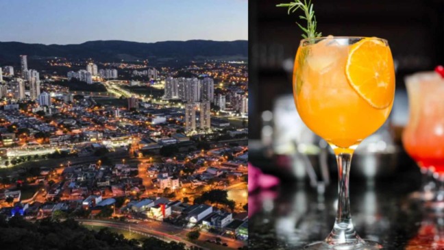 Vista noturna da cidade de Jundiaí iluminada ao lado de um coquetel laranja em taça decorada com fatia de laranja e alecrim. Vista noturna da cidade de Jundiaí iluminada ao lado de um coquetel laranja em taça decorada com fatia de laranja e alecrim.