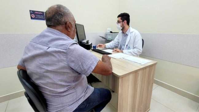 Paciente é atendido por médico durante consulta em unidade de saúde de Jundiaí, representando o cuidado oncológico e o acesso ao tratamento pelo SUS.